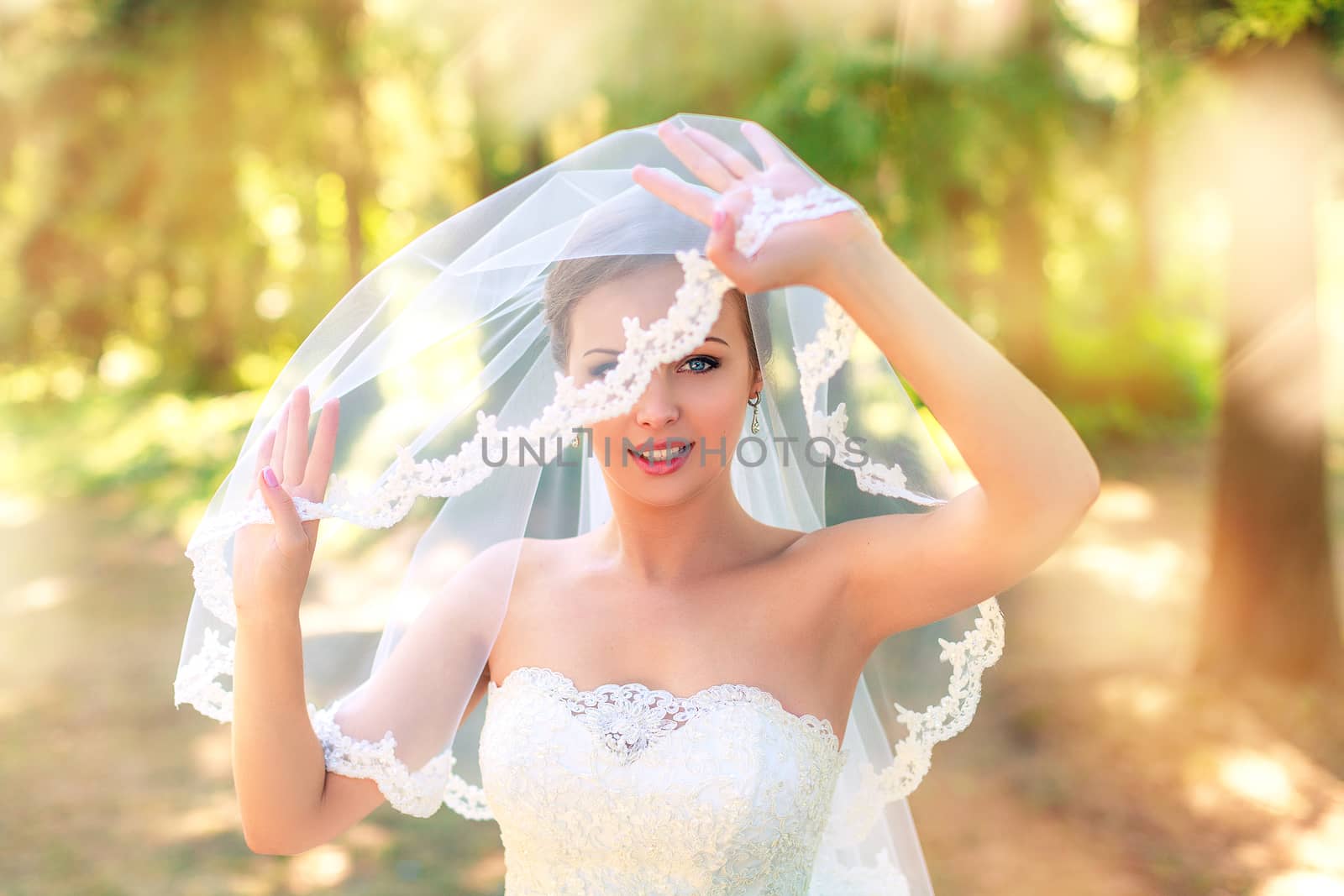 The bride in a white dress on a sunny day