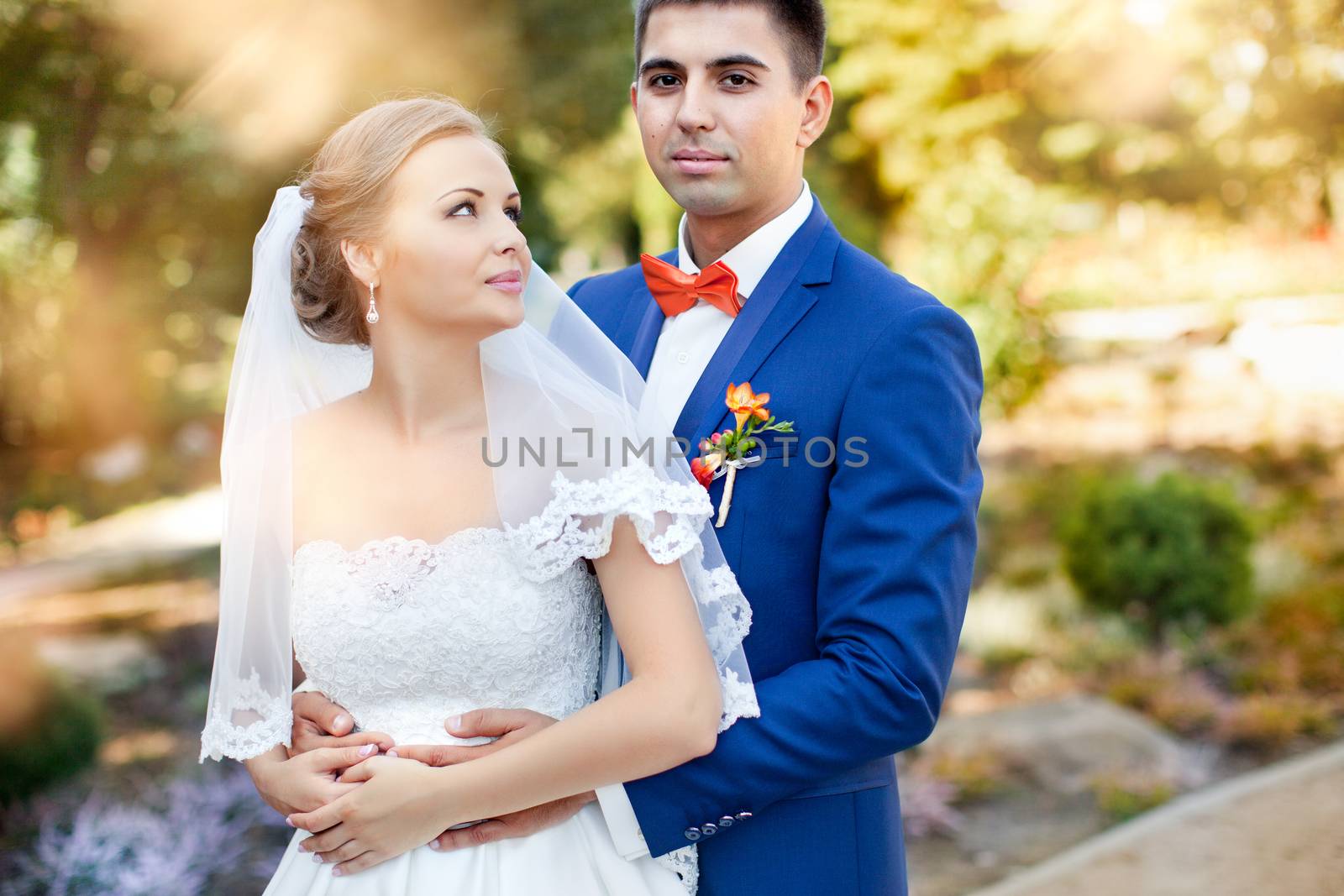 Funny bride and groom on a summer day in the park