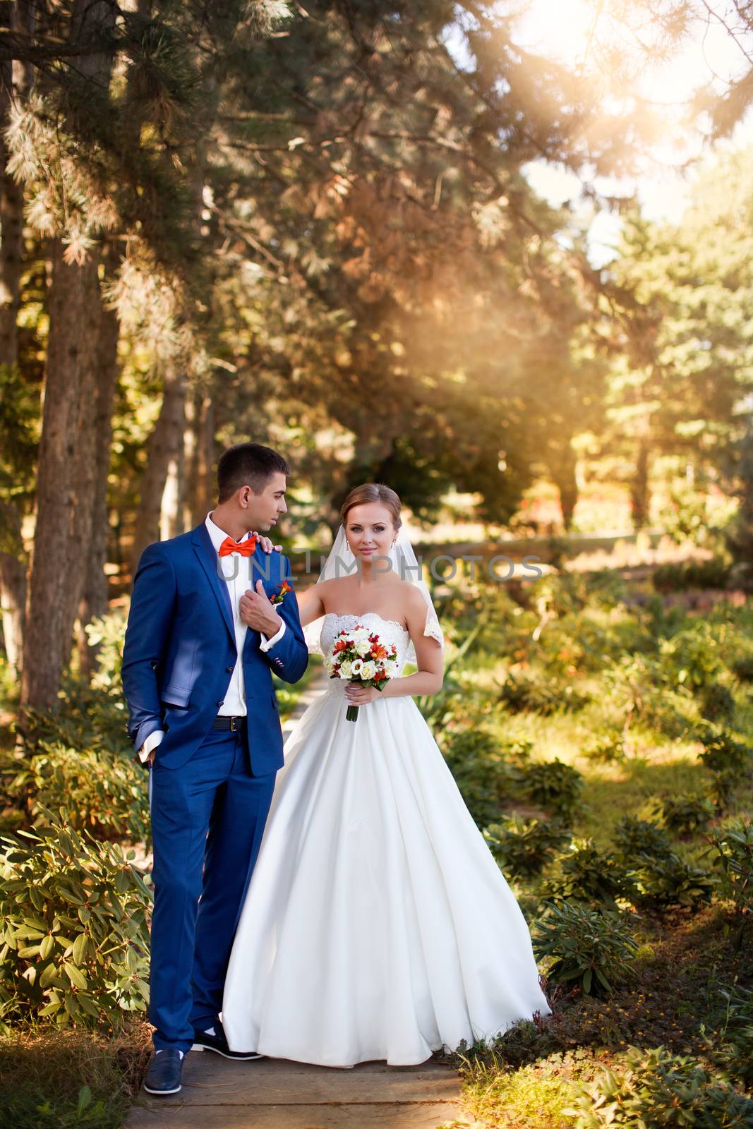 Funny bride and groom on a summer day in the park