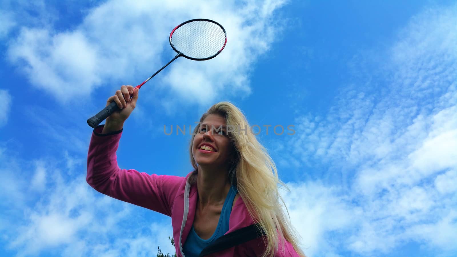 Blblonde girl playing in badminton