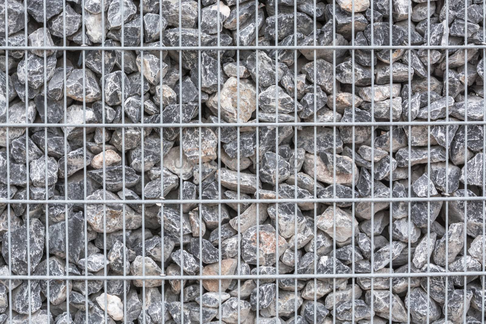 Gabion filled with thick stones; Metal Stone basket with large natural stones for external landscaping.