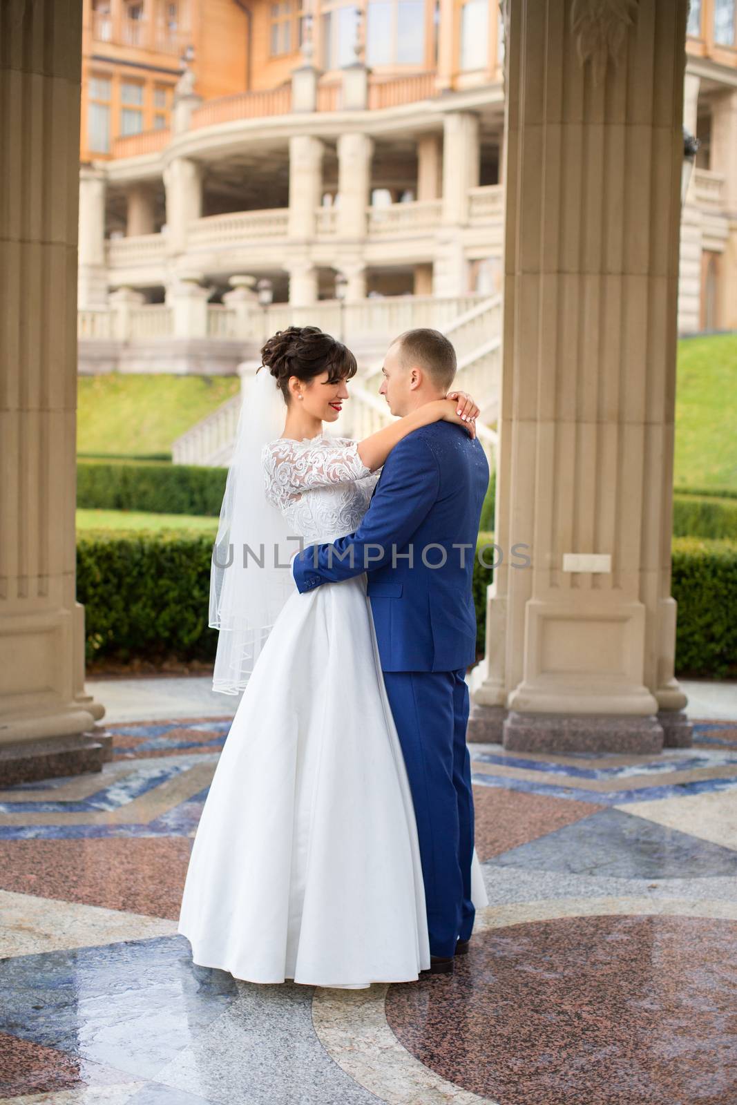 Bride and groom posing in the rain