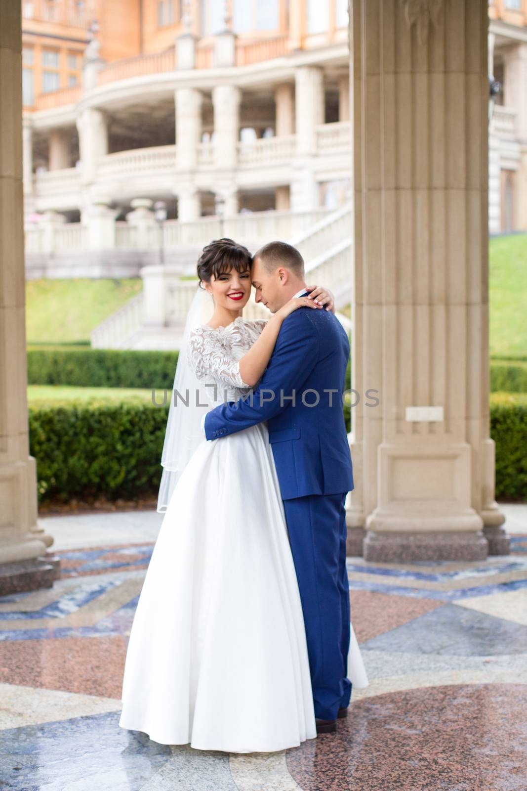 Bride and groom posing in the rain