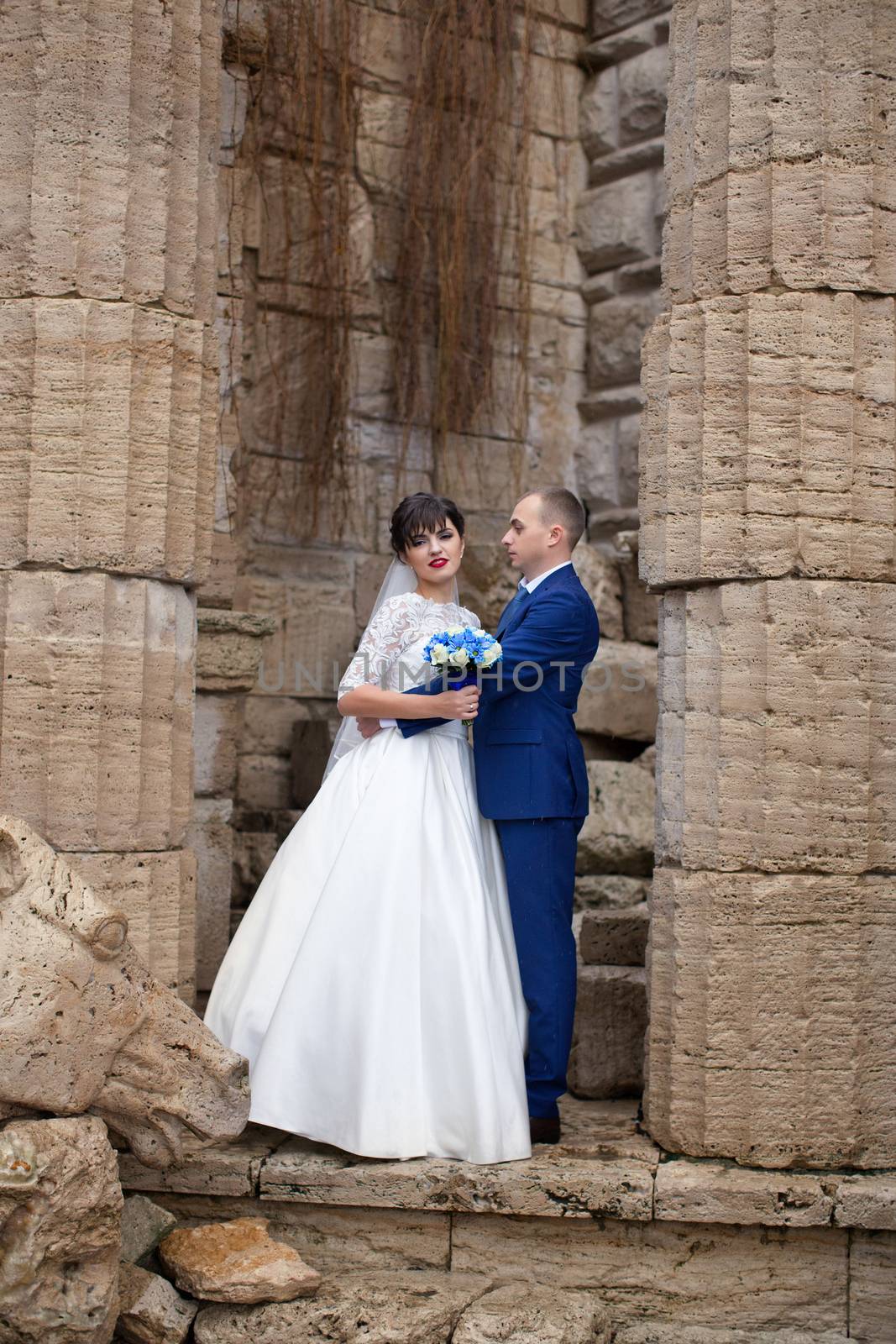 Bride and groom posing in the rain