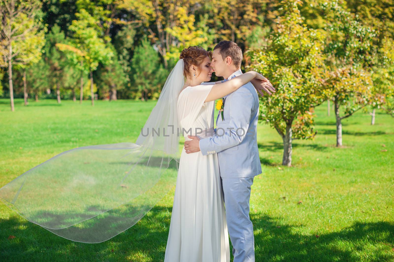 The groom gently embraces the bride by lanser314