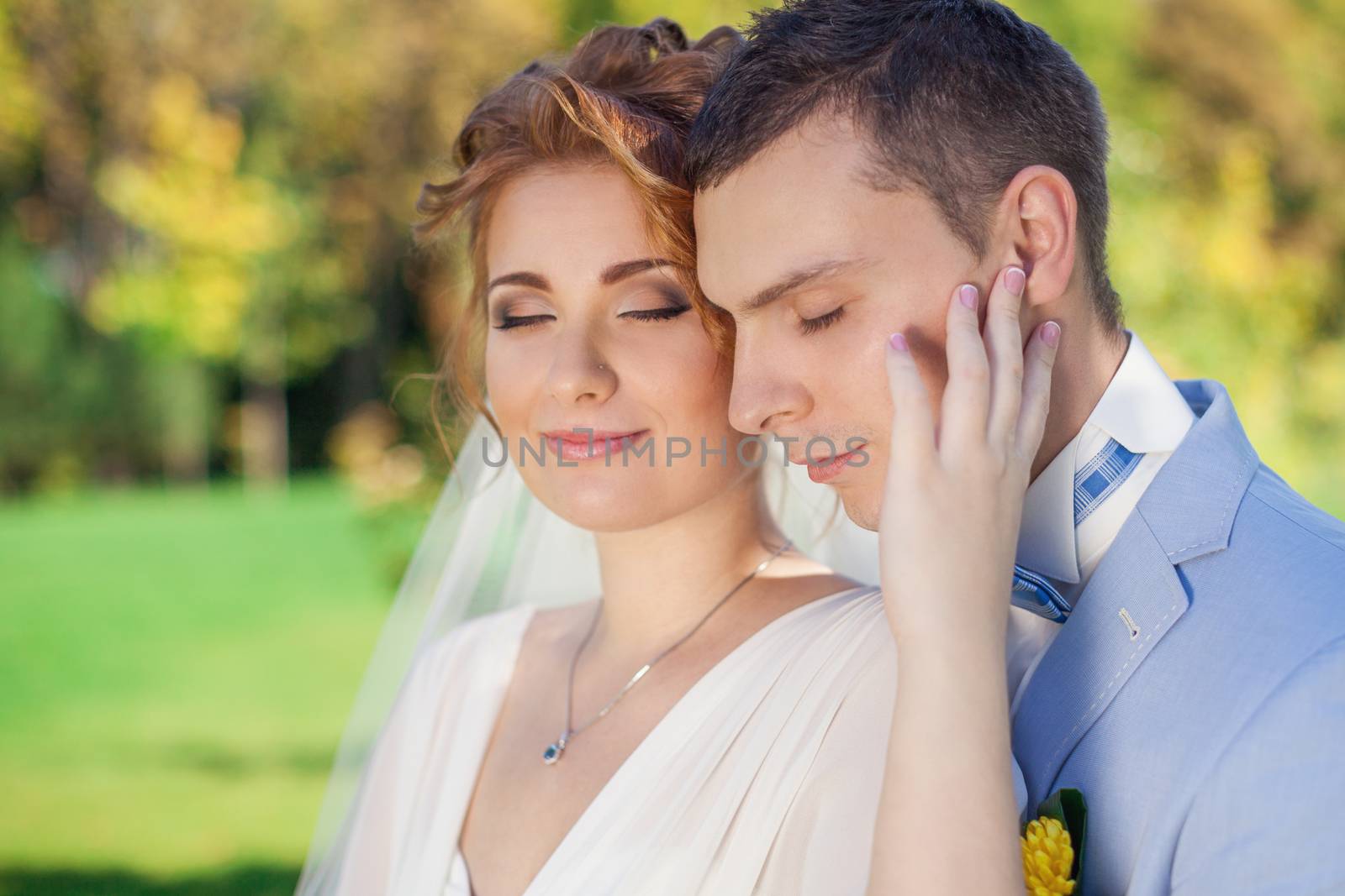 The groom gently embraces the bride by lanser314