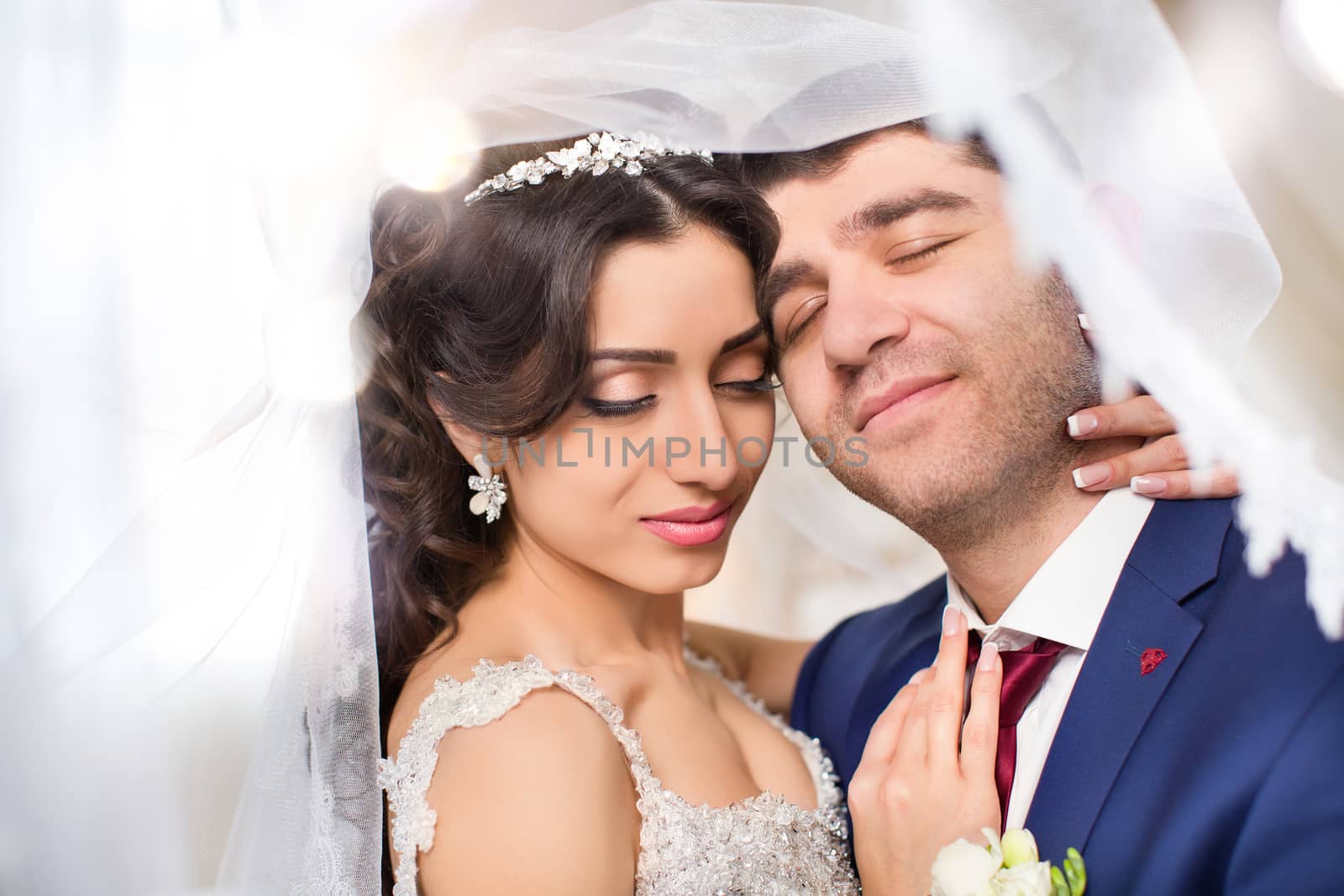 The groom gently hugged the bride on the wedding day