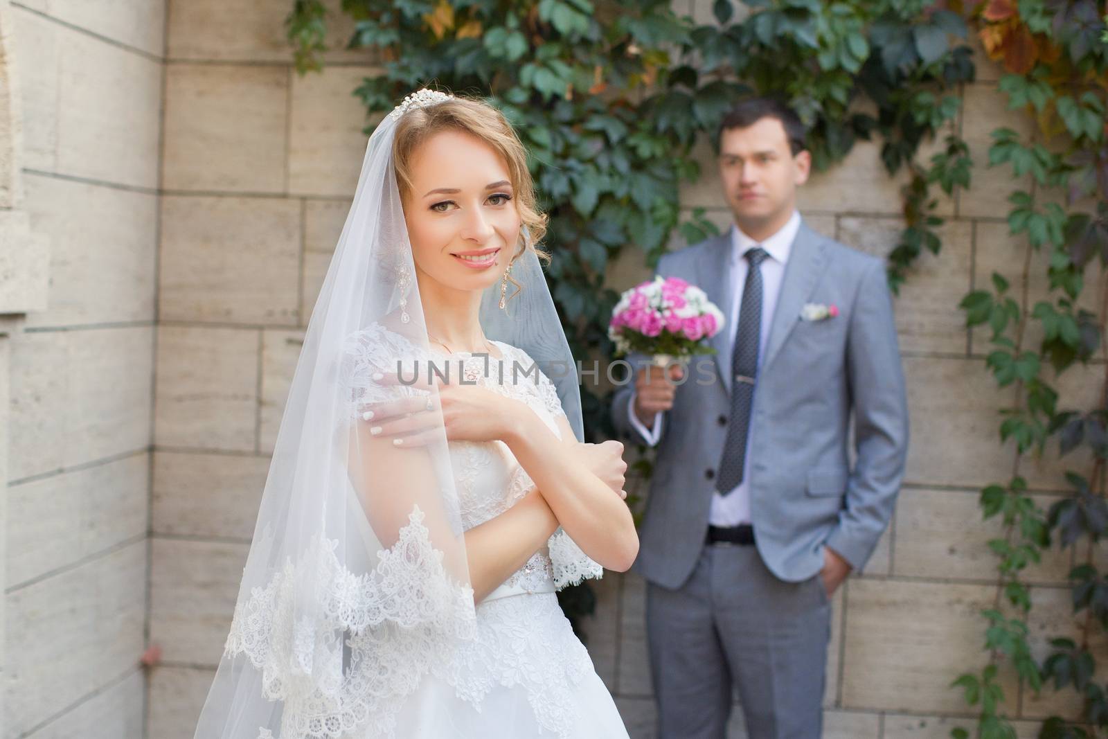 Bride and groom at wedding Day walking Outdoors on spring nature. Bridal couple, Happy Newlywed woman and man embracing in green park. Loving wedding couple outdoor. Bride and groom by lanser314