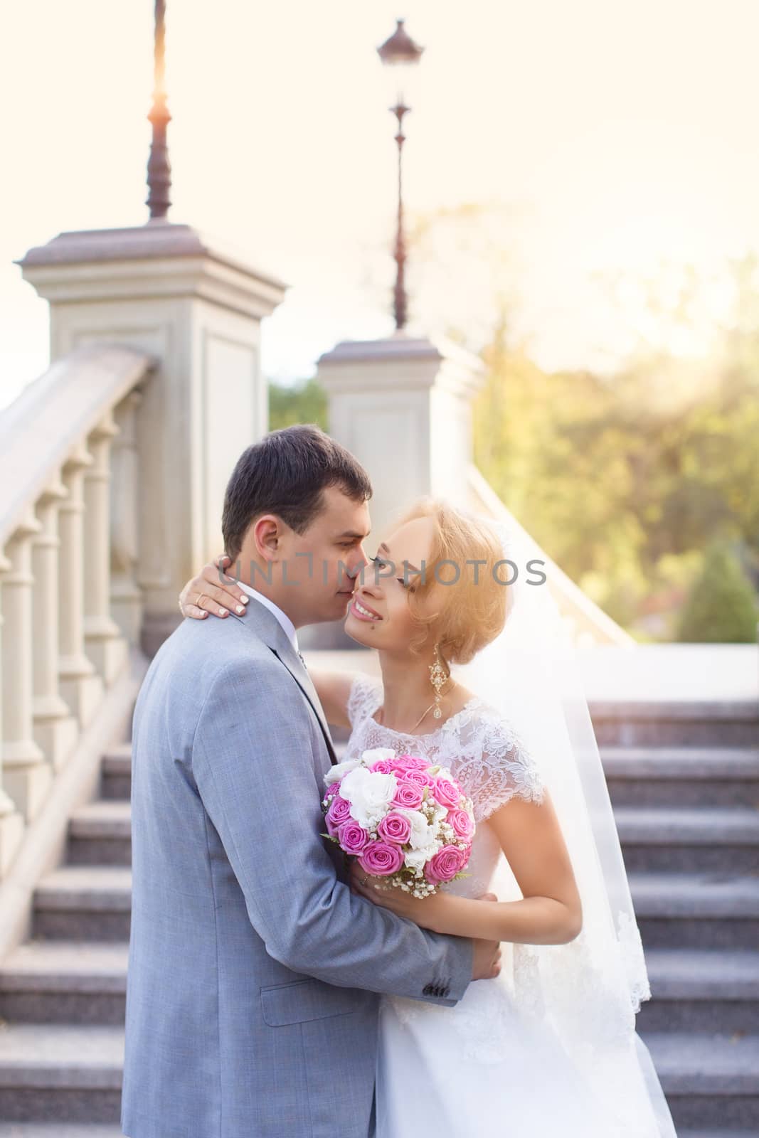 Bride and groom at wedding Day walking Outdoors on spring nature. Bridal couple, Happy Newlywed woman and man embracing in green park. Loving wedding couple outdoor. Bride and groom by lanser314