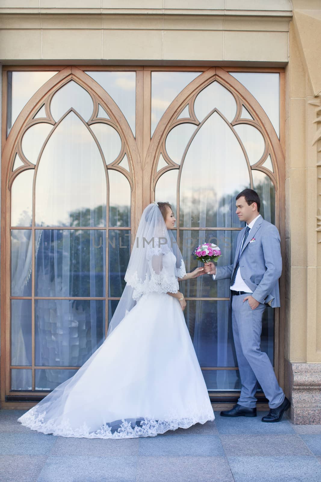 Bride and groom at wedding Day walking Outdoors on spring nature. Bridal couple, Happy Newlywed woman and man embracing in green park. Loving wedding couple outdoor. Bride and groom by lanser314