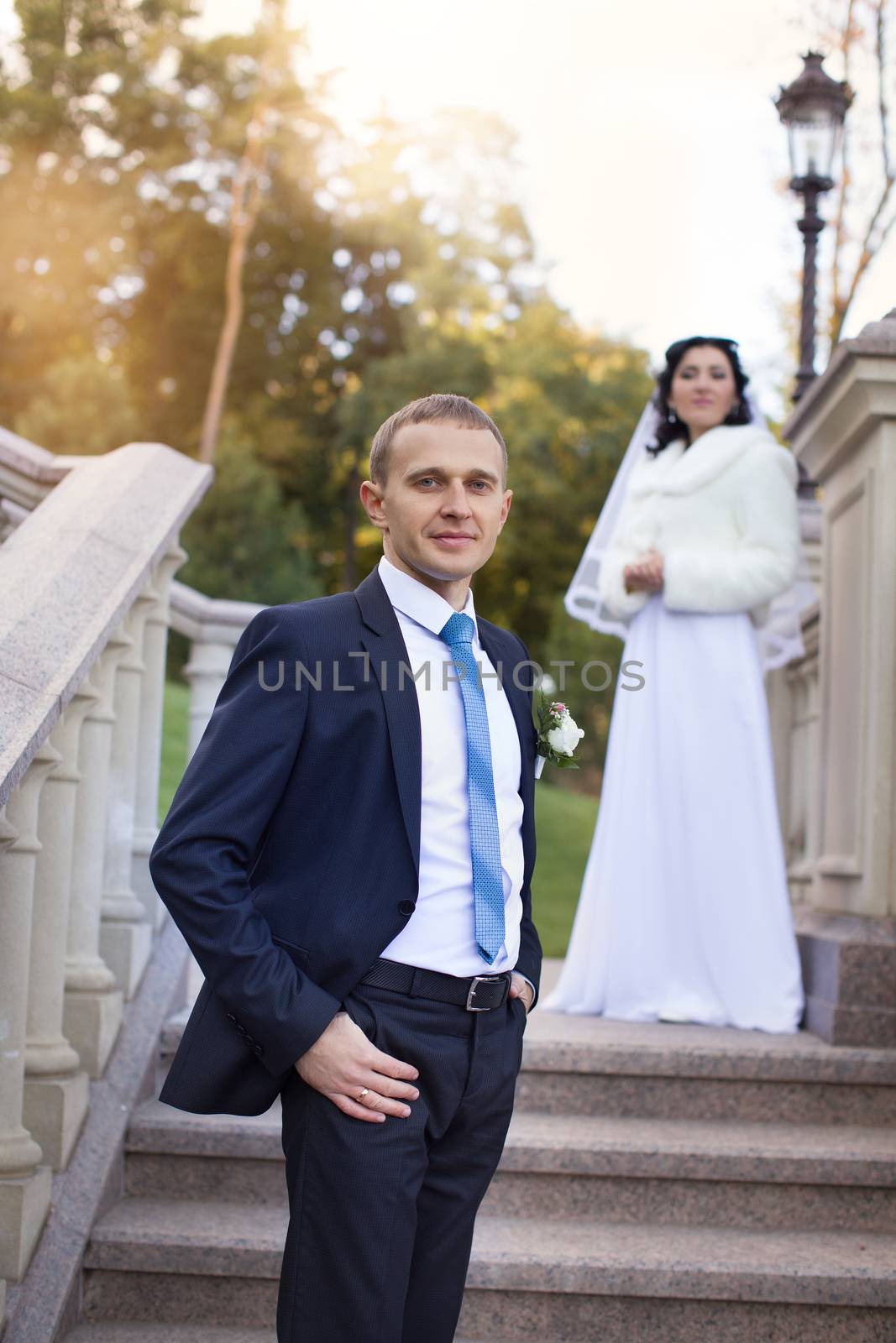 the groom gently embraces and kisses the bride