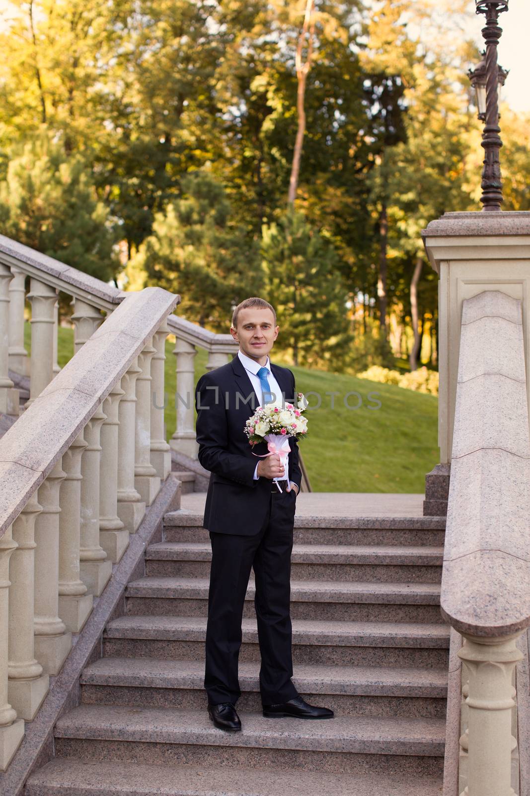 Stylish groom in suit by lanser314