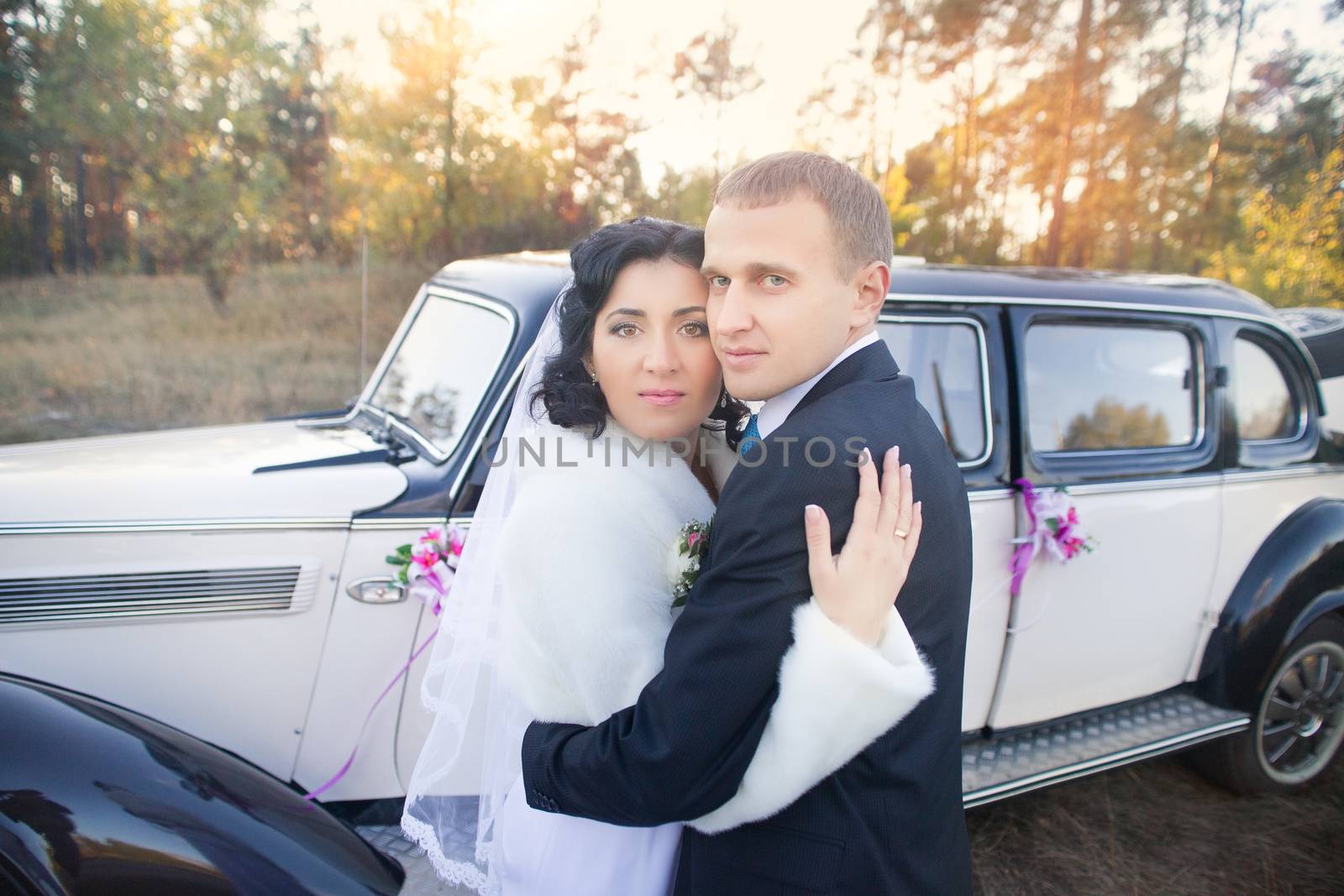 Young couple sitting  inside retro car by lanser314