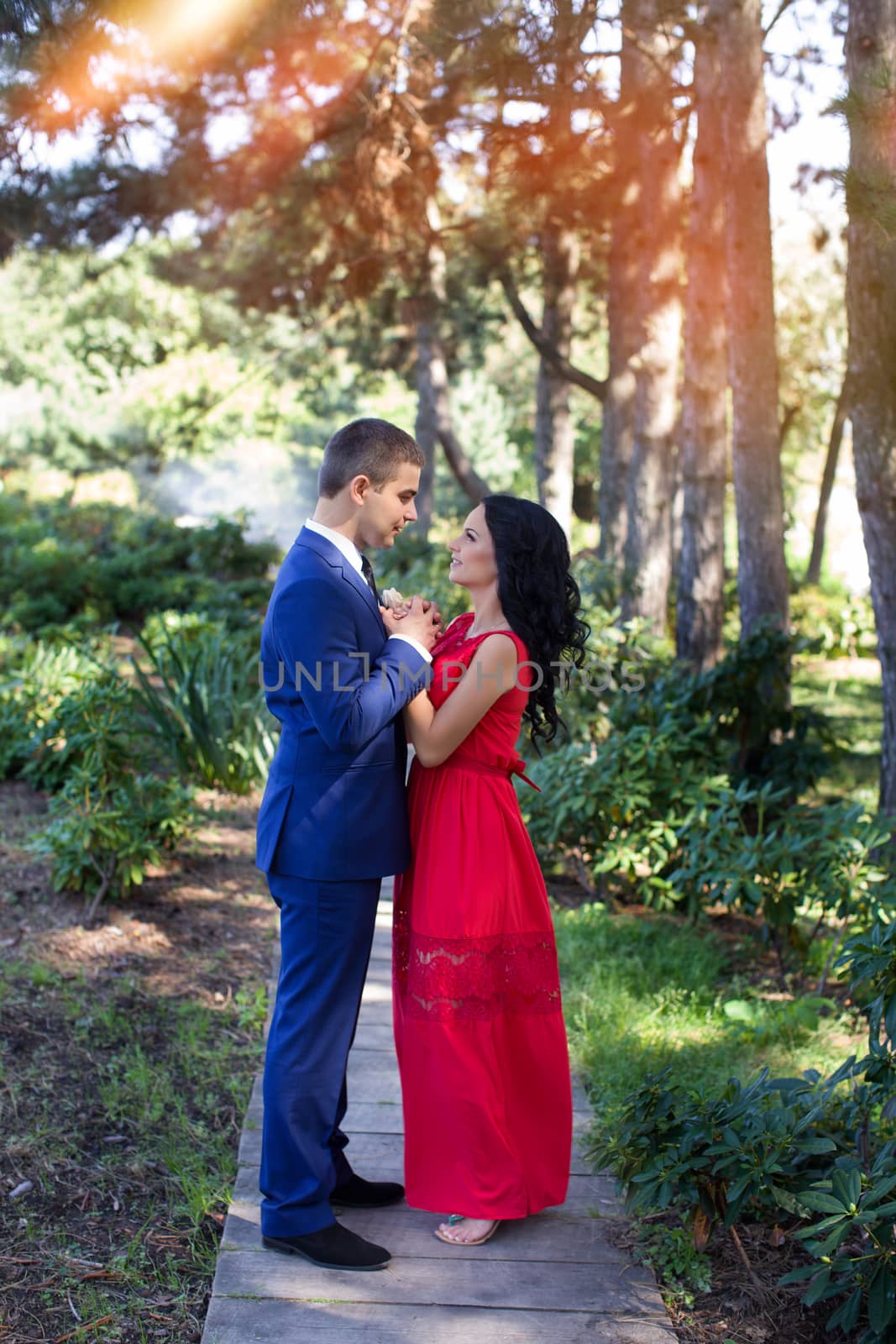 Woman hugging a man she in love with and smile outdoors