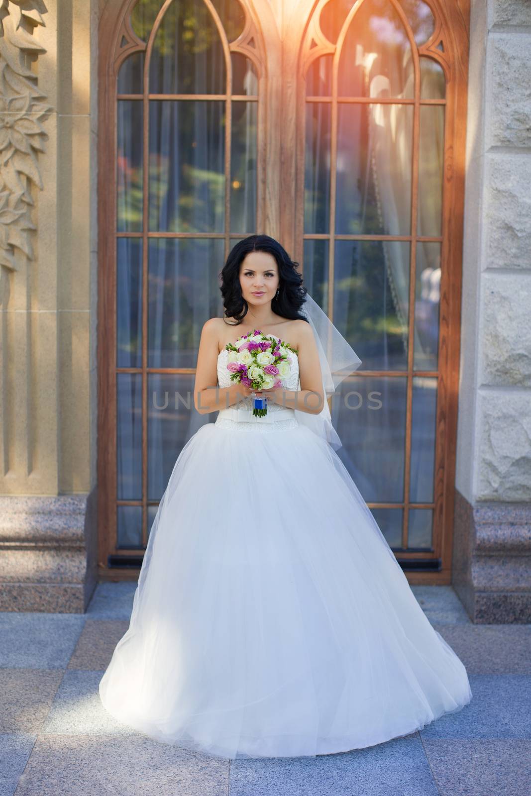 portrait of a brown-eyed sensual kinky girl in white dress on the window background, close up