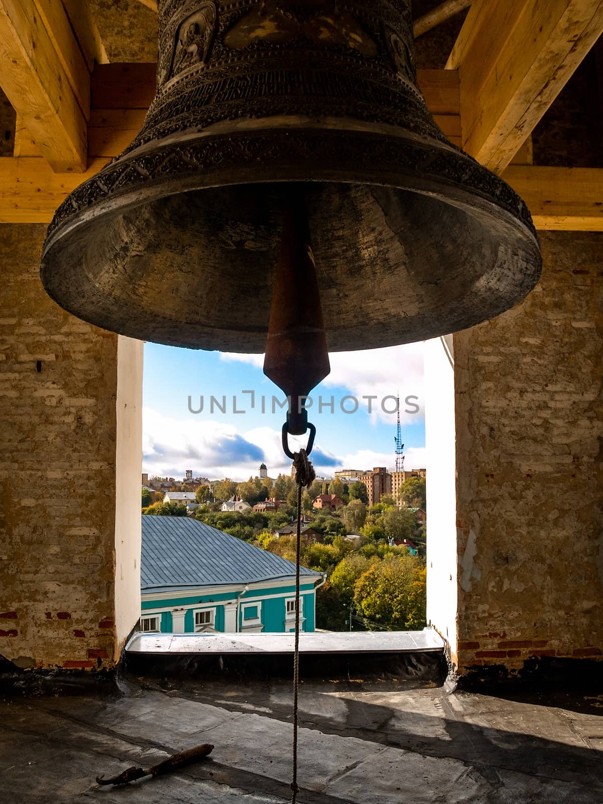 Large brass bell in the temple of the urban landscape a warm autumn day