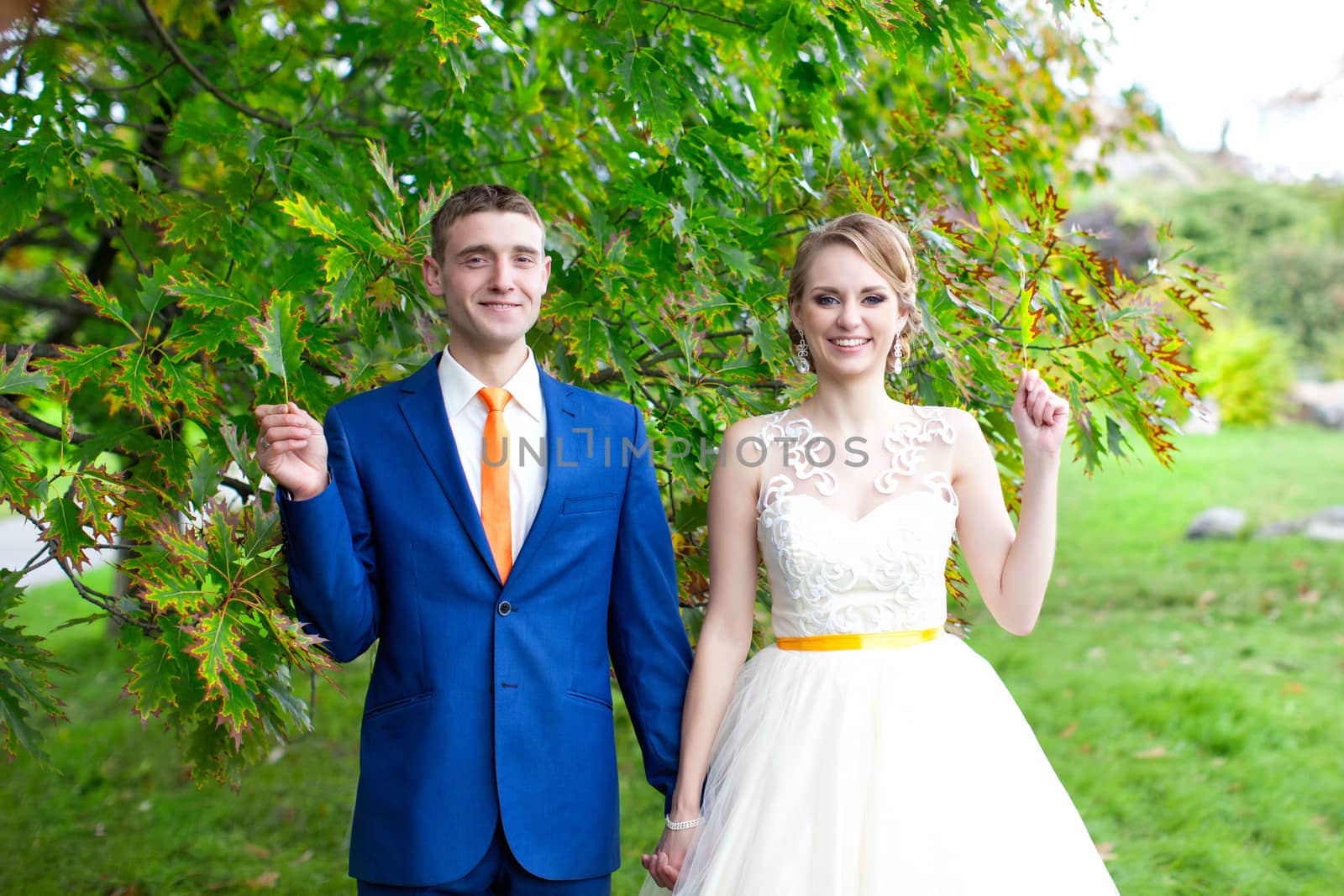 Newlyweds walks away outdoors. Railroad in the forest