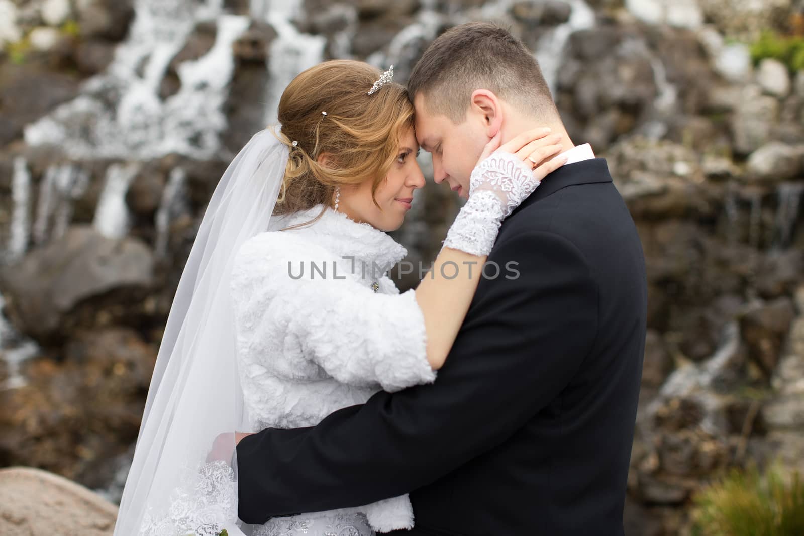 happy beautiful bride and groom walking on field. Loving wedding couple outdoor. Bride and groom.Wedding concept.