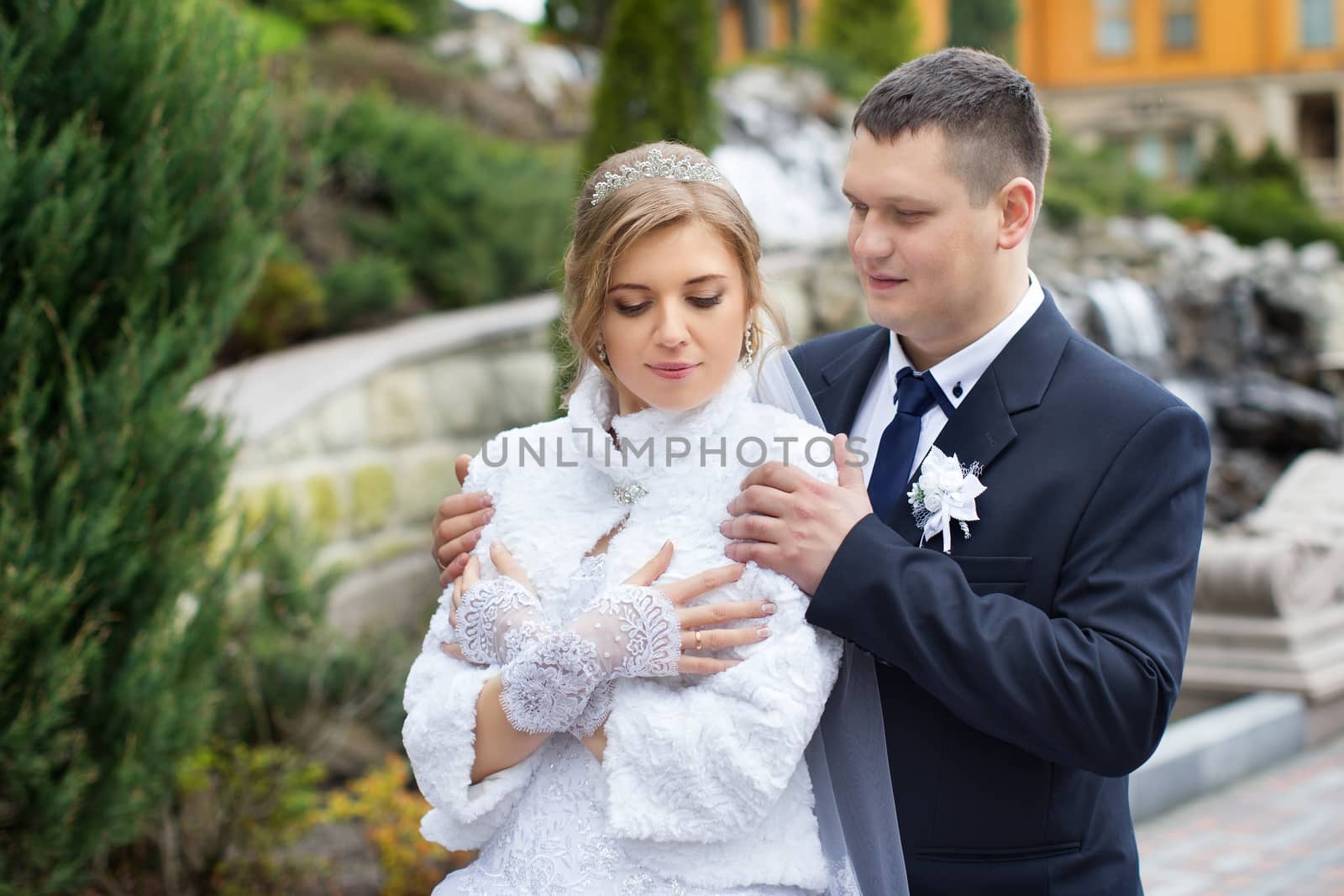 happy beautiful bride and groom walking on field. Loving wedding couple outdoor. Bride and groom.Wedding concept.