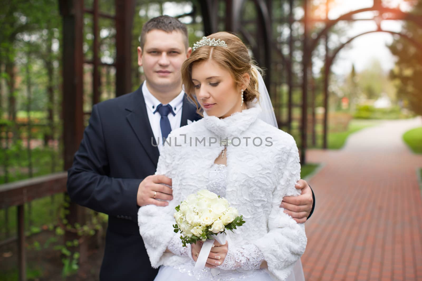 happy beautiful bride and groom walking on field. Loving wedding couple outdoor. Bride and groom.Wedding concept.