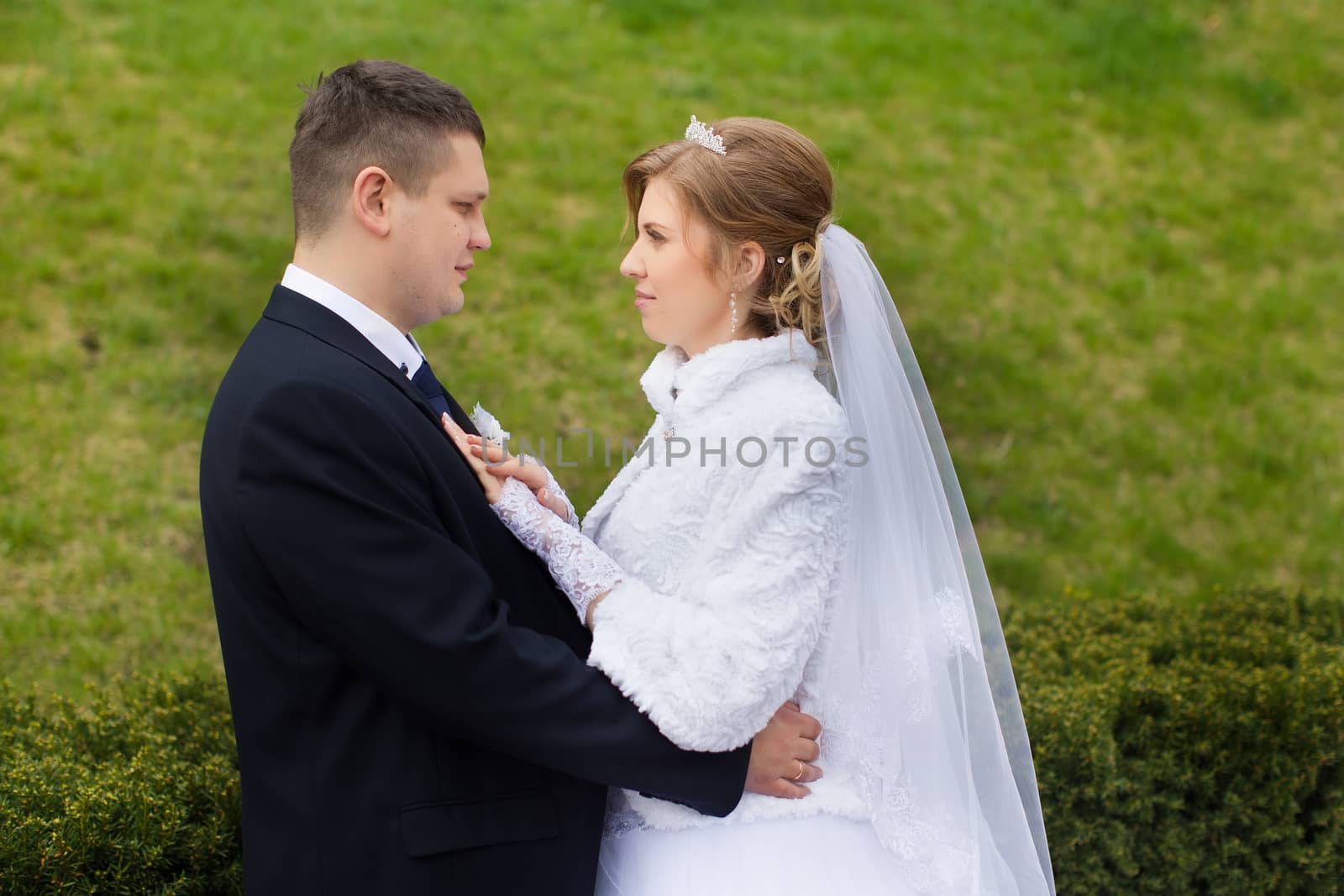 happy beautiful bride and groom walking on field. Loving wedding couple outdoor. Bride and groom.Wedding concept.