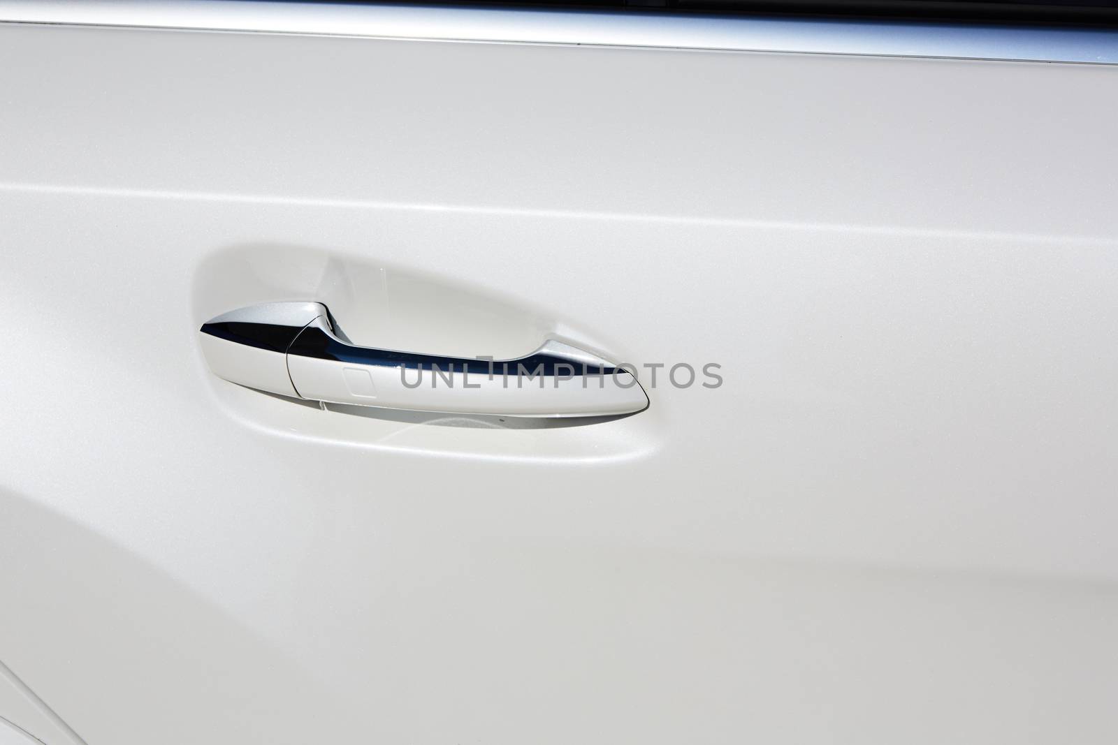 The white car door handle. Close up