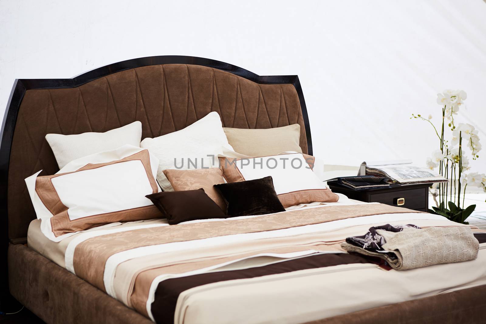 Interior of a bedroom in brown tones. Modern classics
