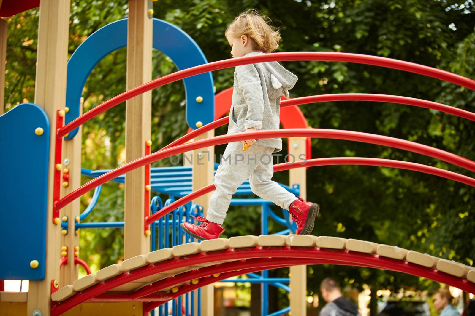 A girl playing at the playground in the park