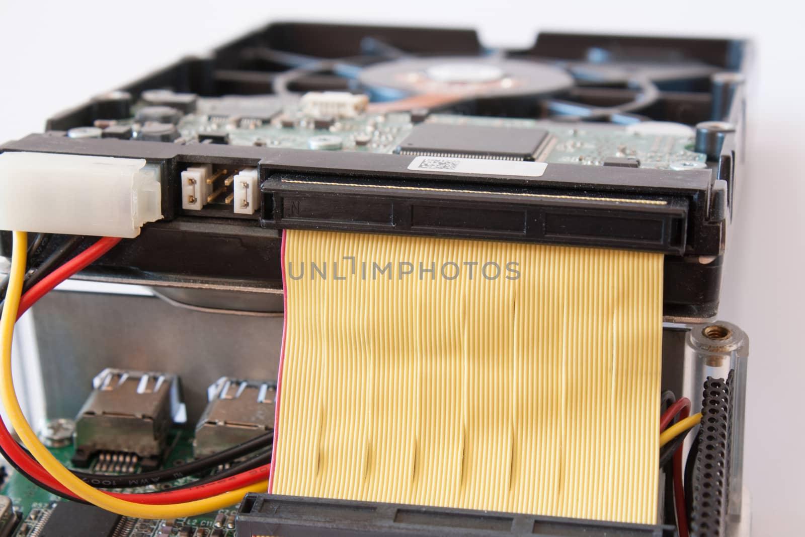 Closeup IDE Harddisk is connecting to electronic board isolated on white background