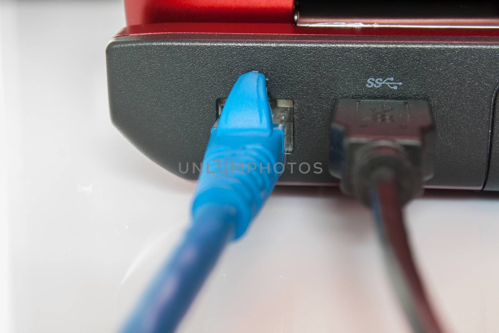 Connected patch cable to laptop, plug with internet cable and la by oodfon