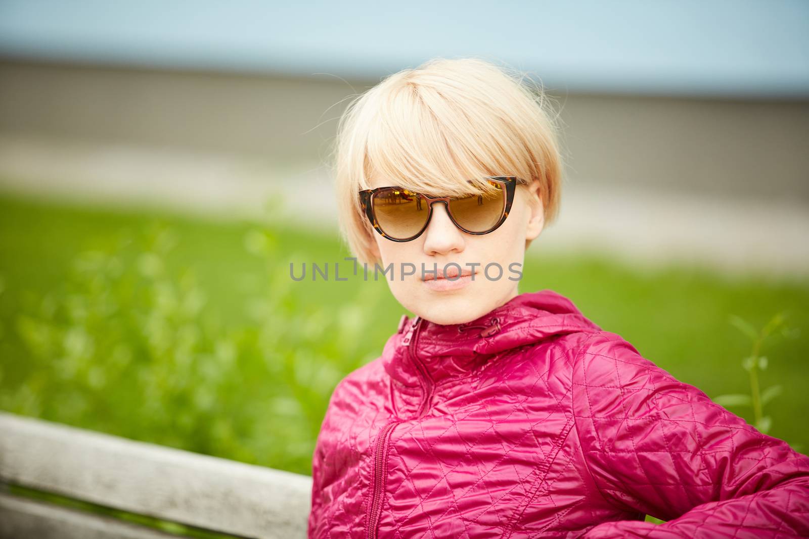 Young woman with blond hair in sunglasses by sarymsakov