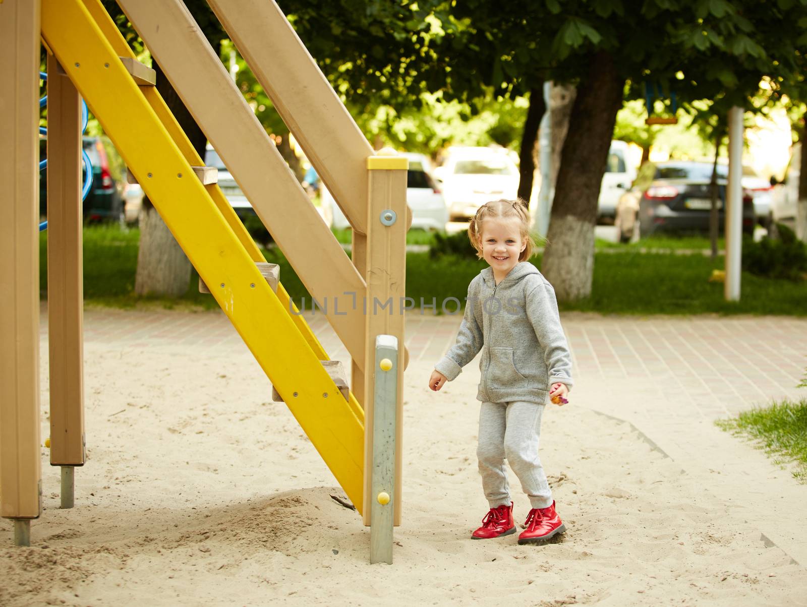 girl playing at the playground by sarymsakov