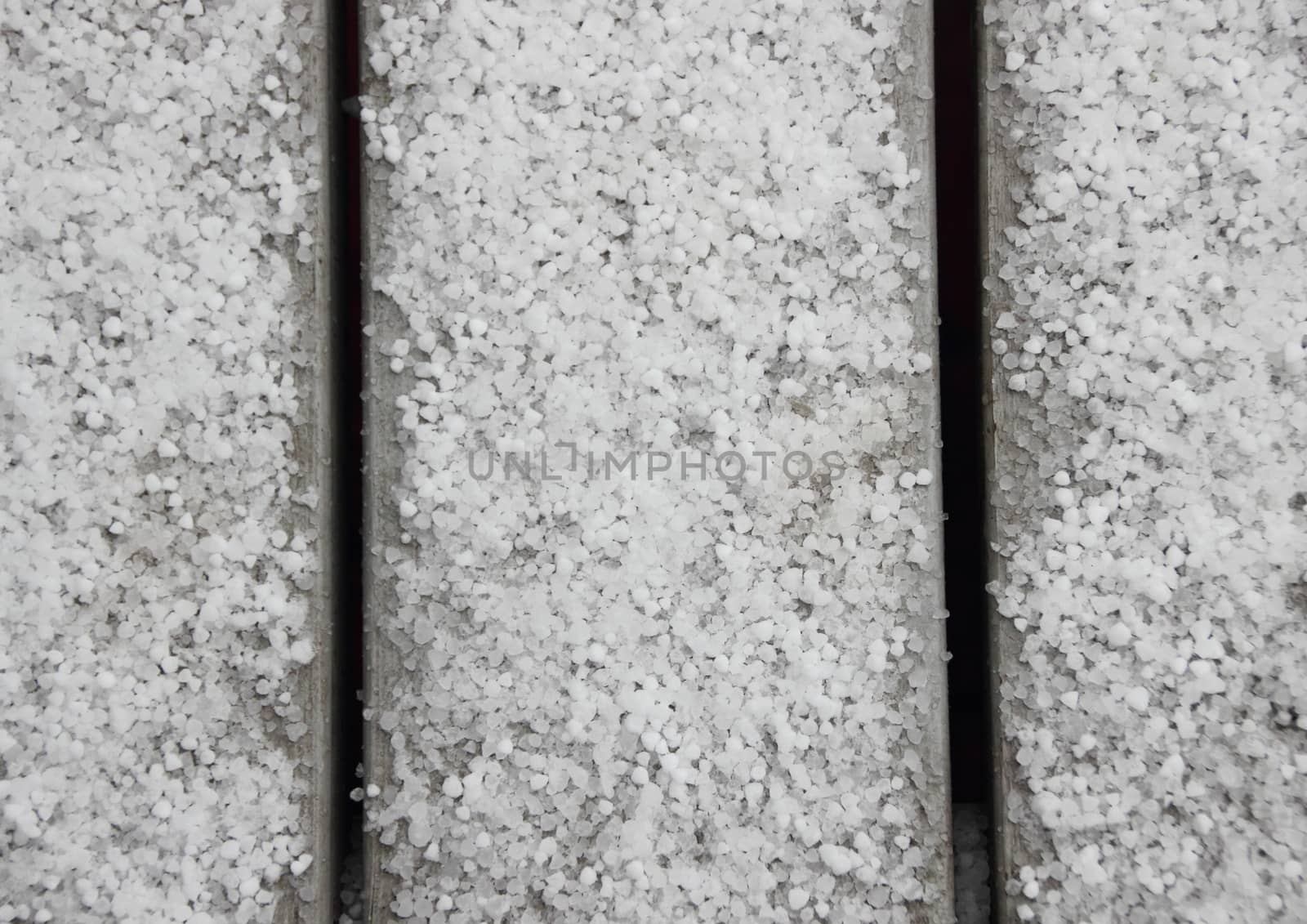 White hail on grey table outside in bird view