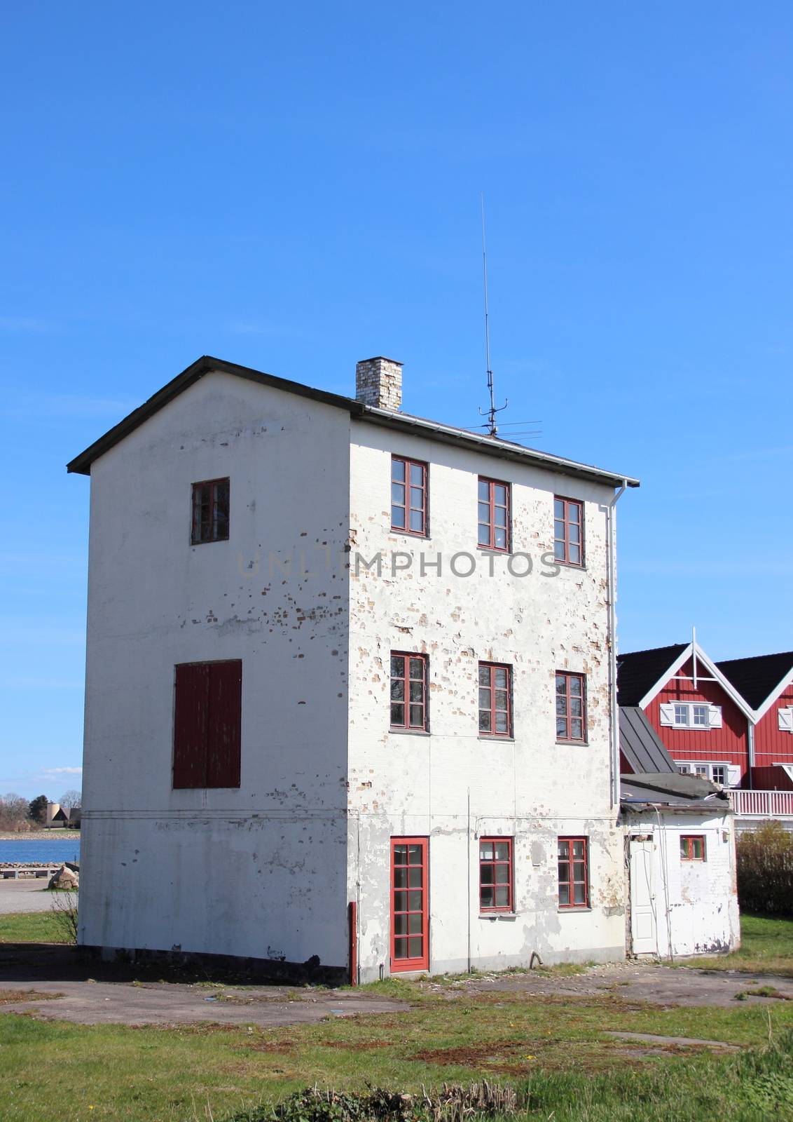 Isolated abandoned three storage building near new houses