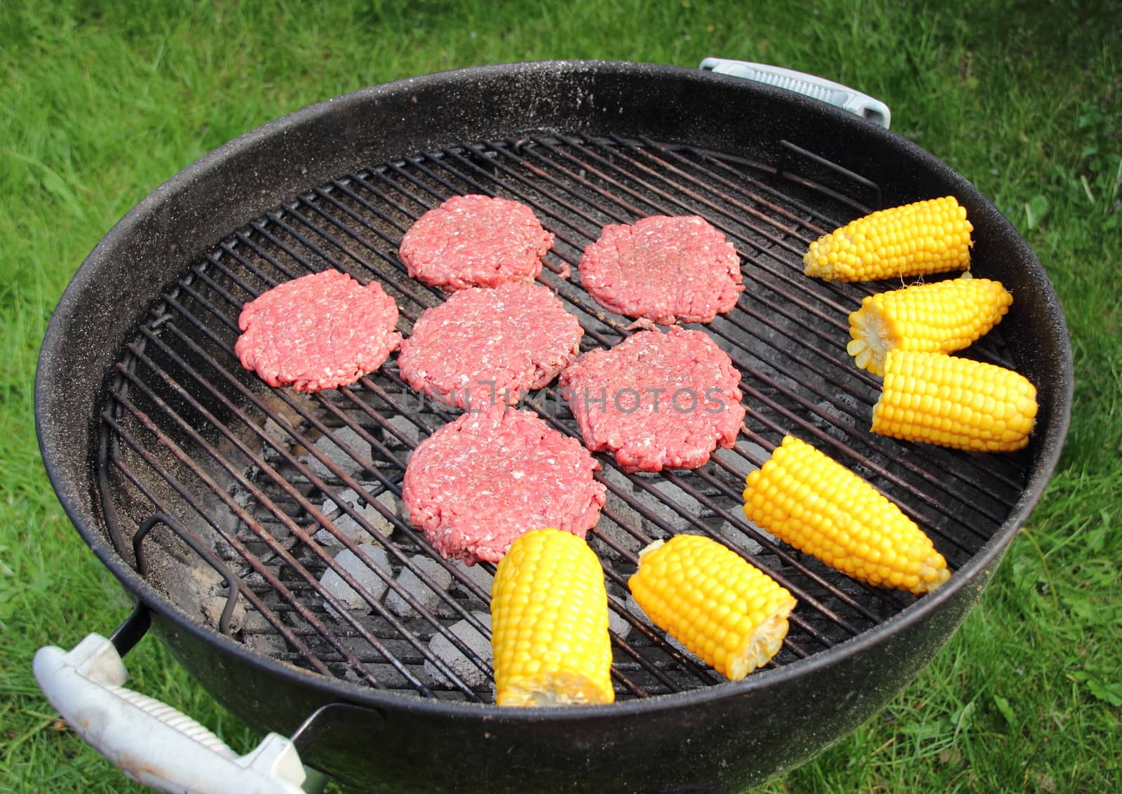 Barbeque grill with beef burger and corncob