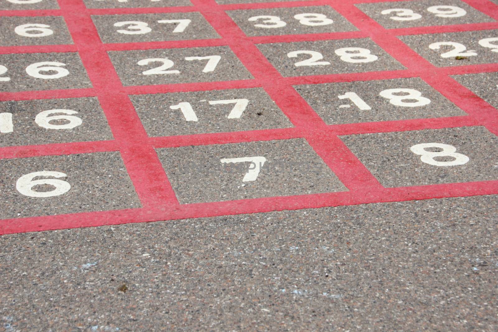 Number seven in red line matrix on asphalt
