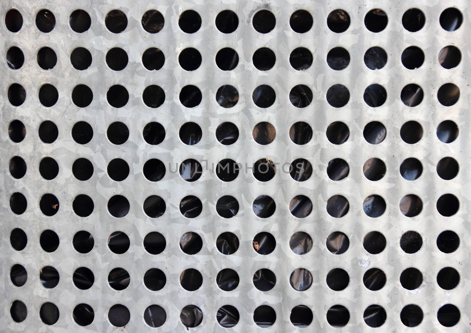 Closeup on steel barrel with black plastic inside