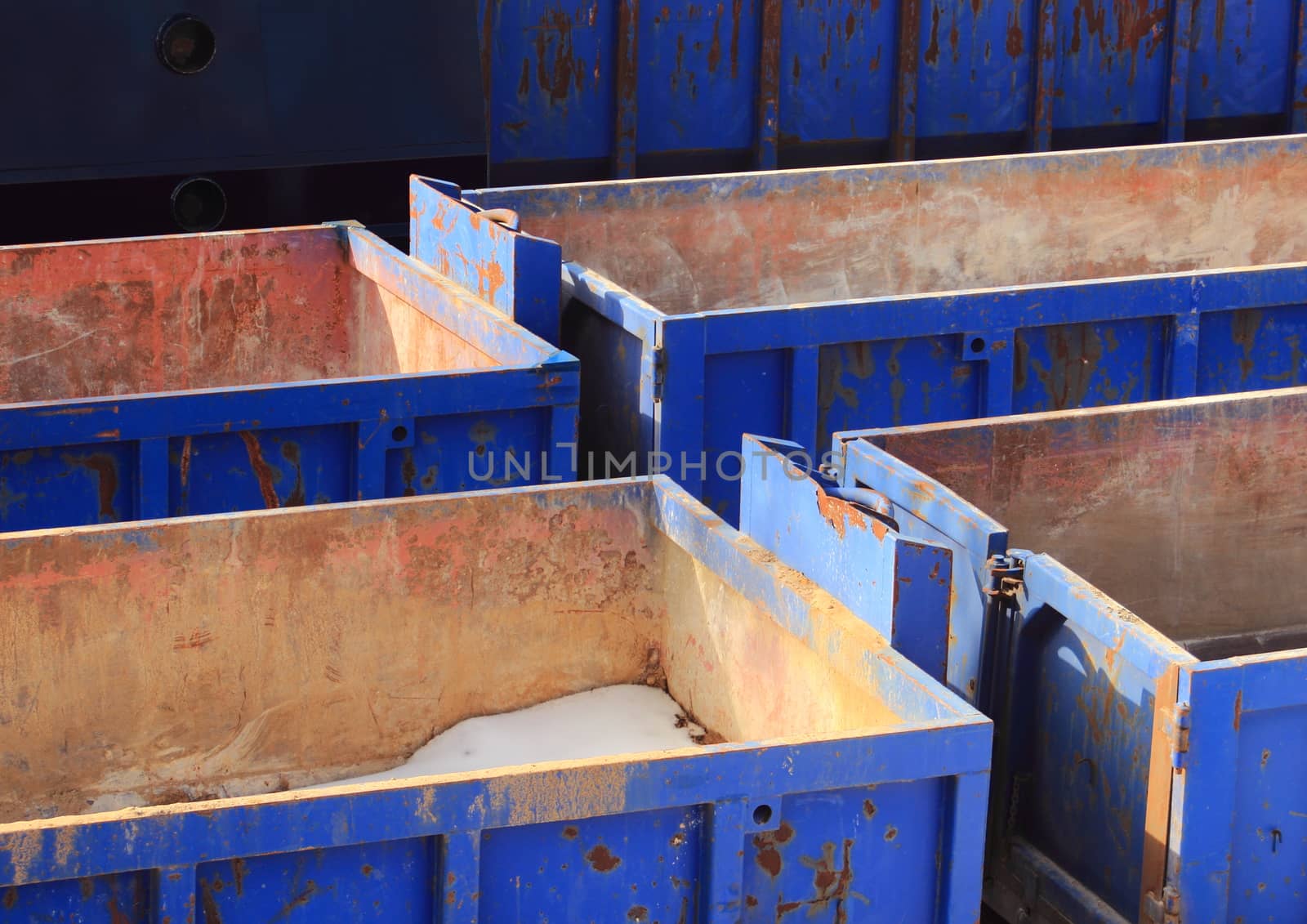 Collection of empty blue containers in winter