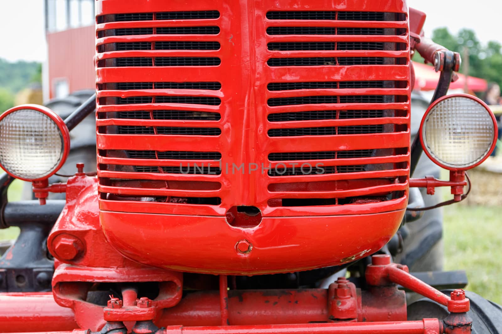 Close-up of the grille of a shiny red tractor