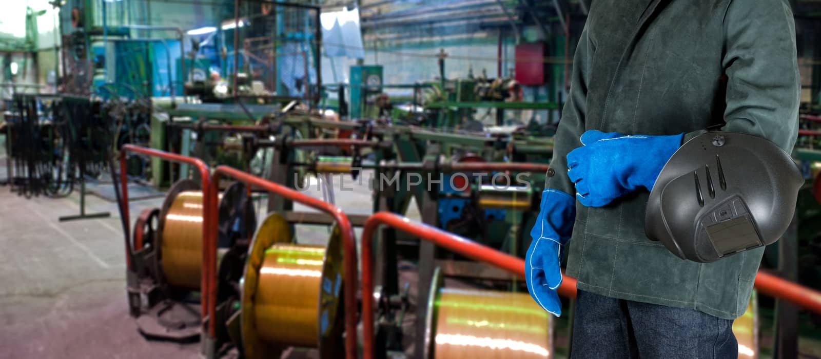 Worker welder with instruments at industrial factory