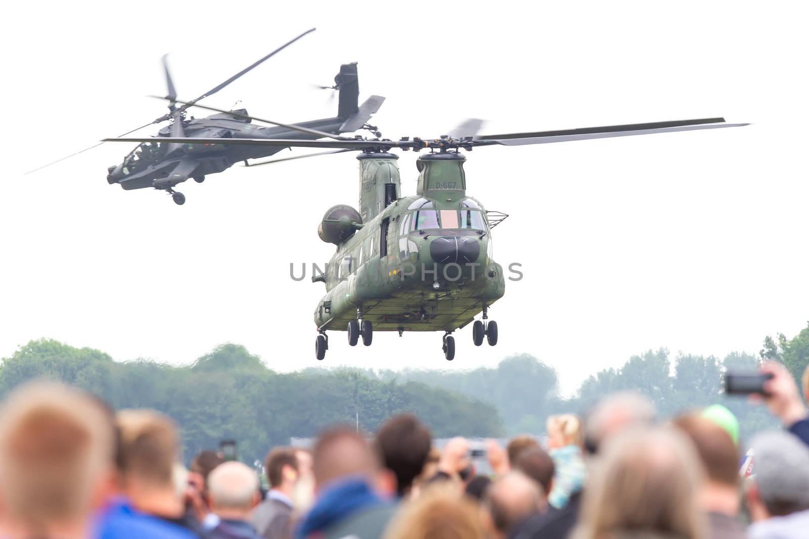 LEEUWARDEN, THE NETHERLANDS - JUN 11, 2016: Dutch Chinook and Apache helicopter flying during the Royal Netherlands Air Force Days
