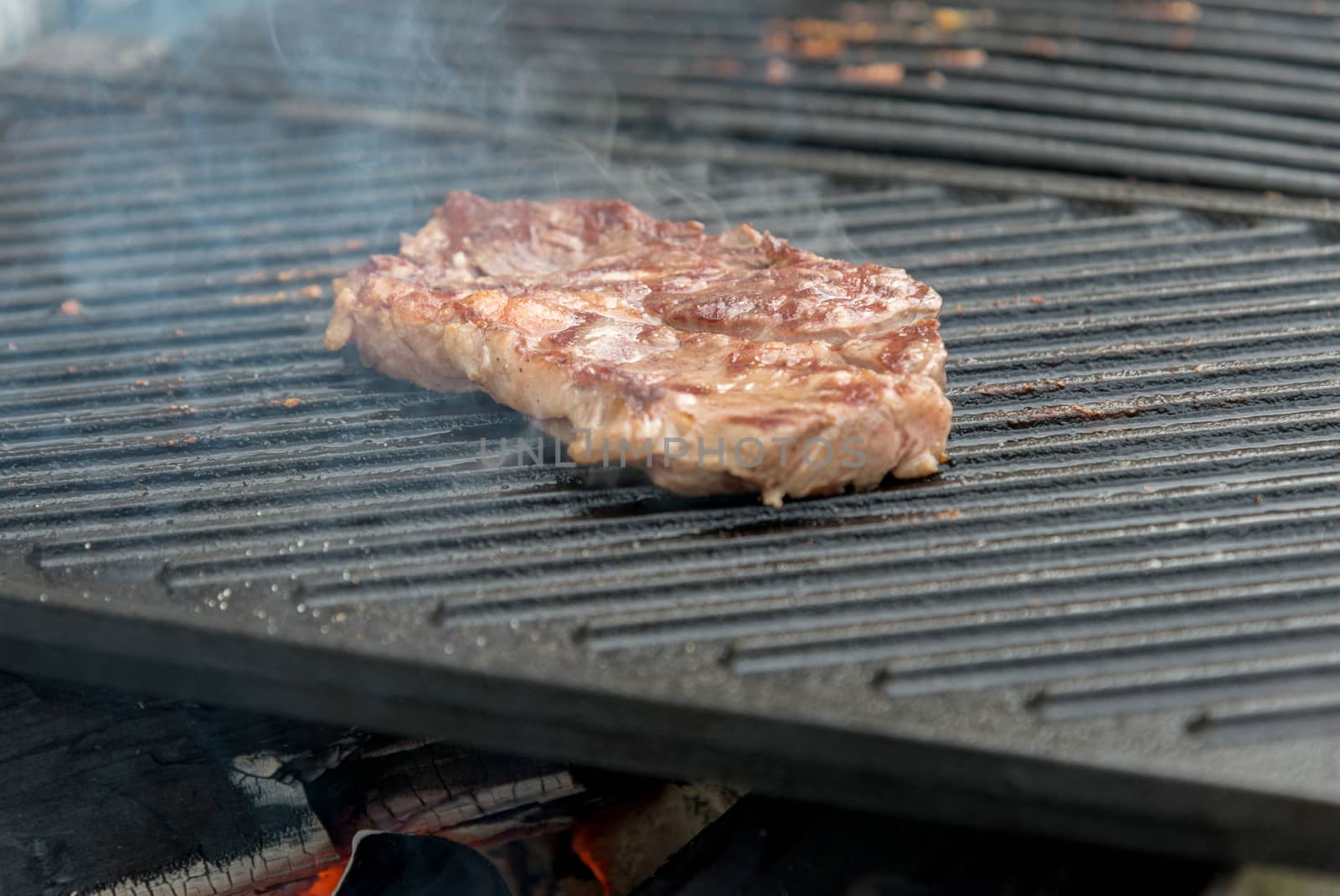 beef steaks on the grill by vlaru