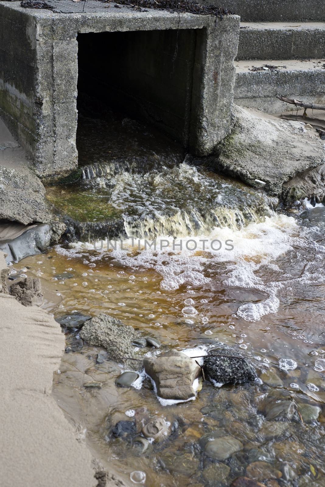 water flowing from a storm drain by morrbyte