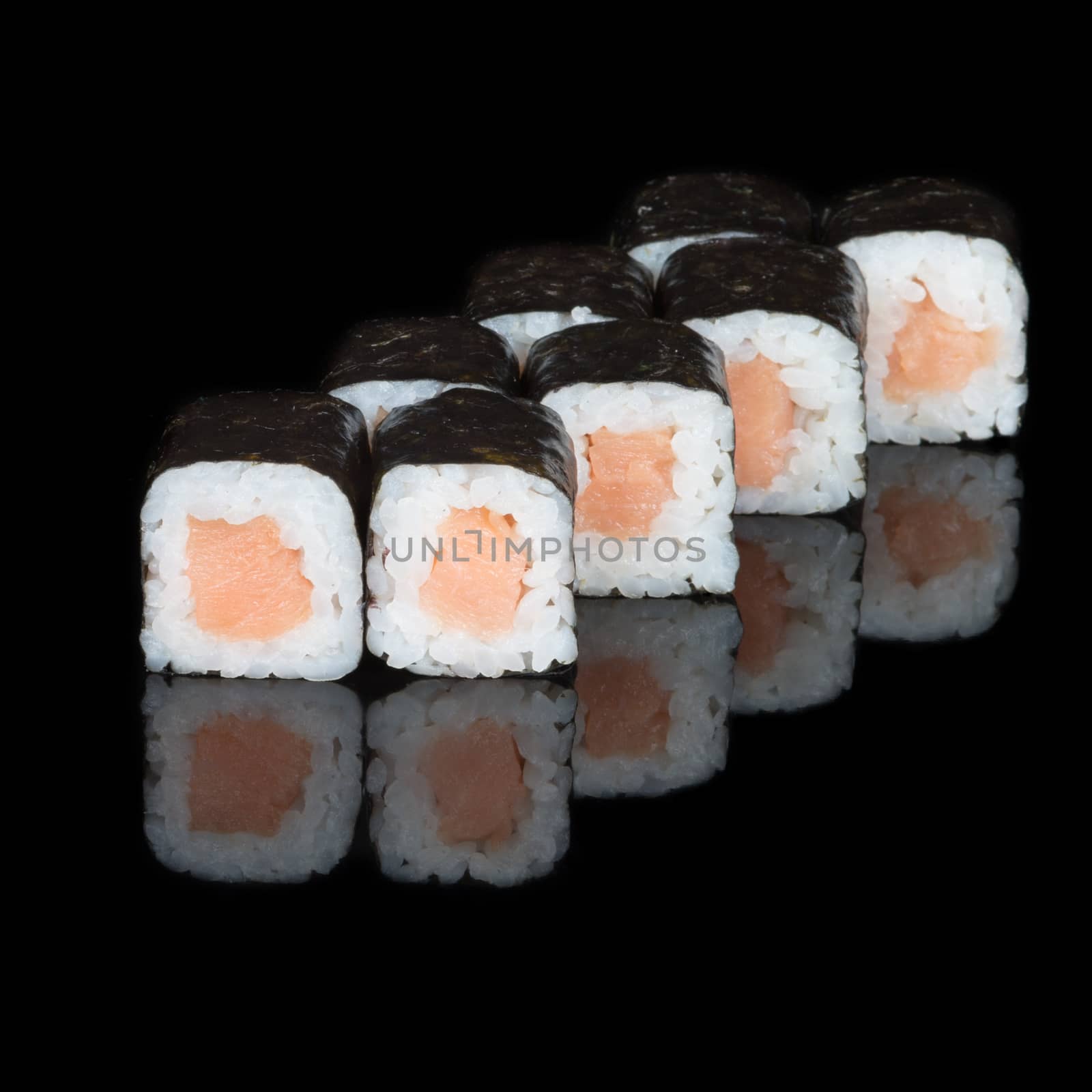 Sushi rolls with salmon on  black background