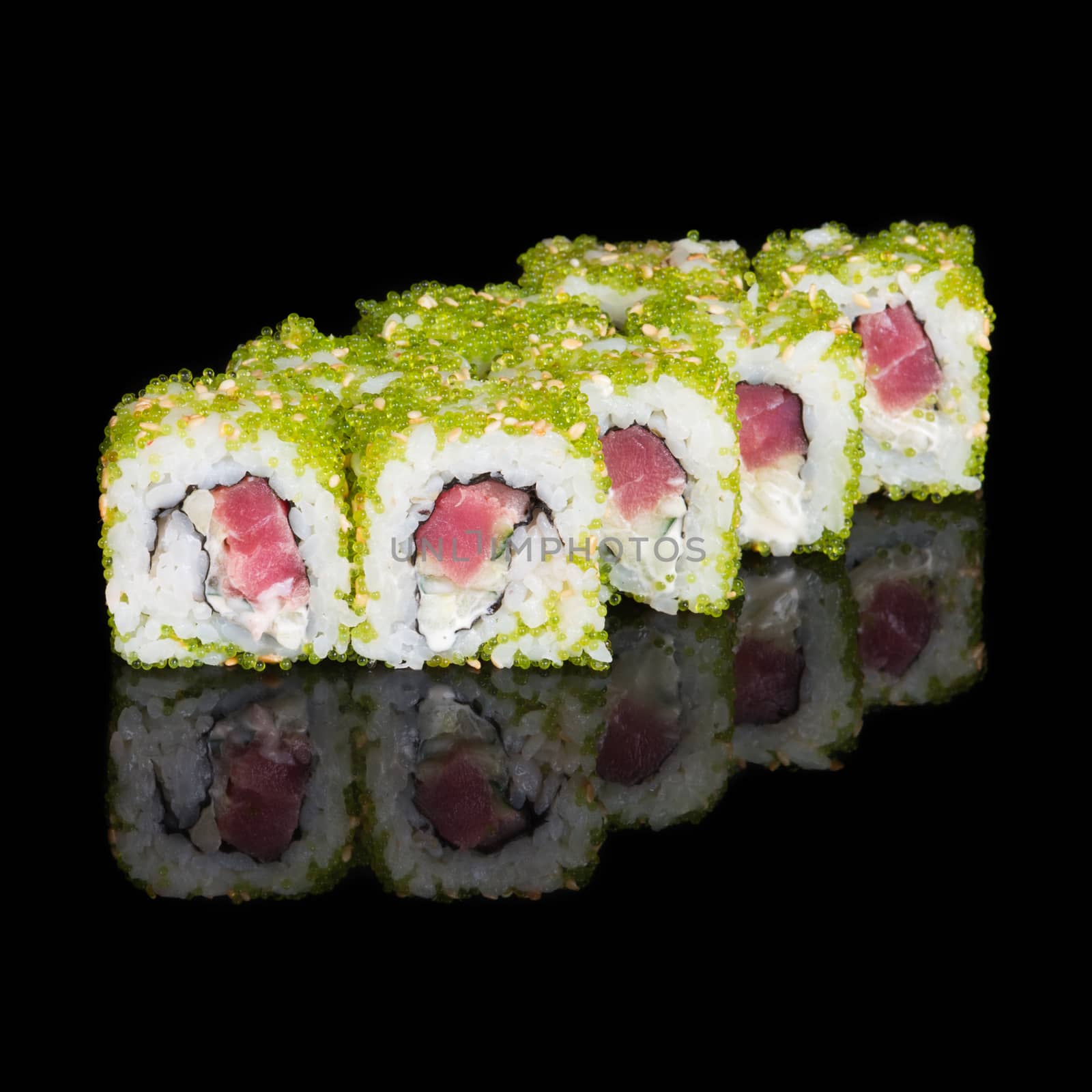 Sushi rolls with tuna, cucumber and flying fish roe on black background