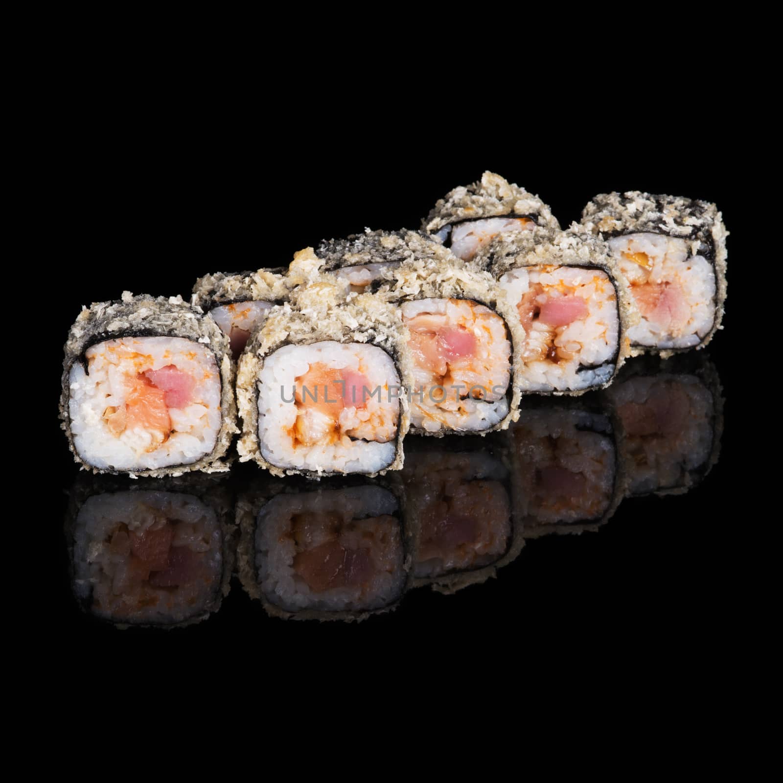 Grilled sushi rolls with salmon, tuna and eel on black background