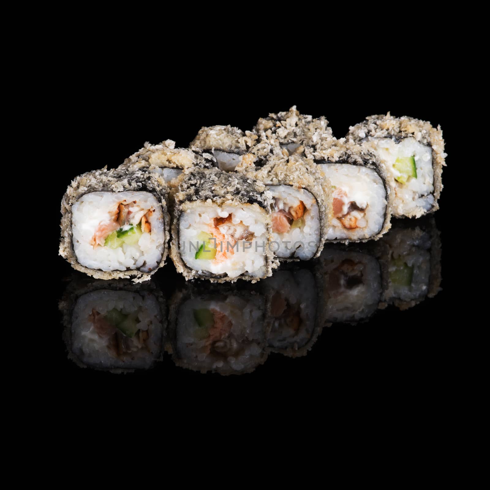 Grilled sushi rolls with salmon and eel on black background