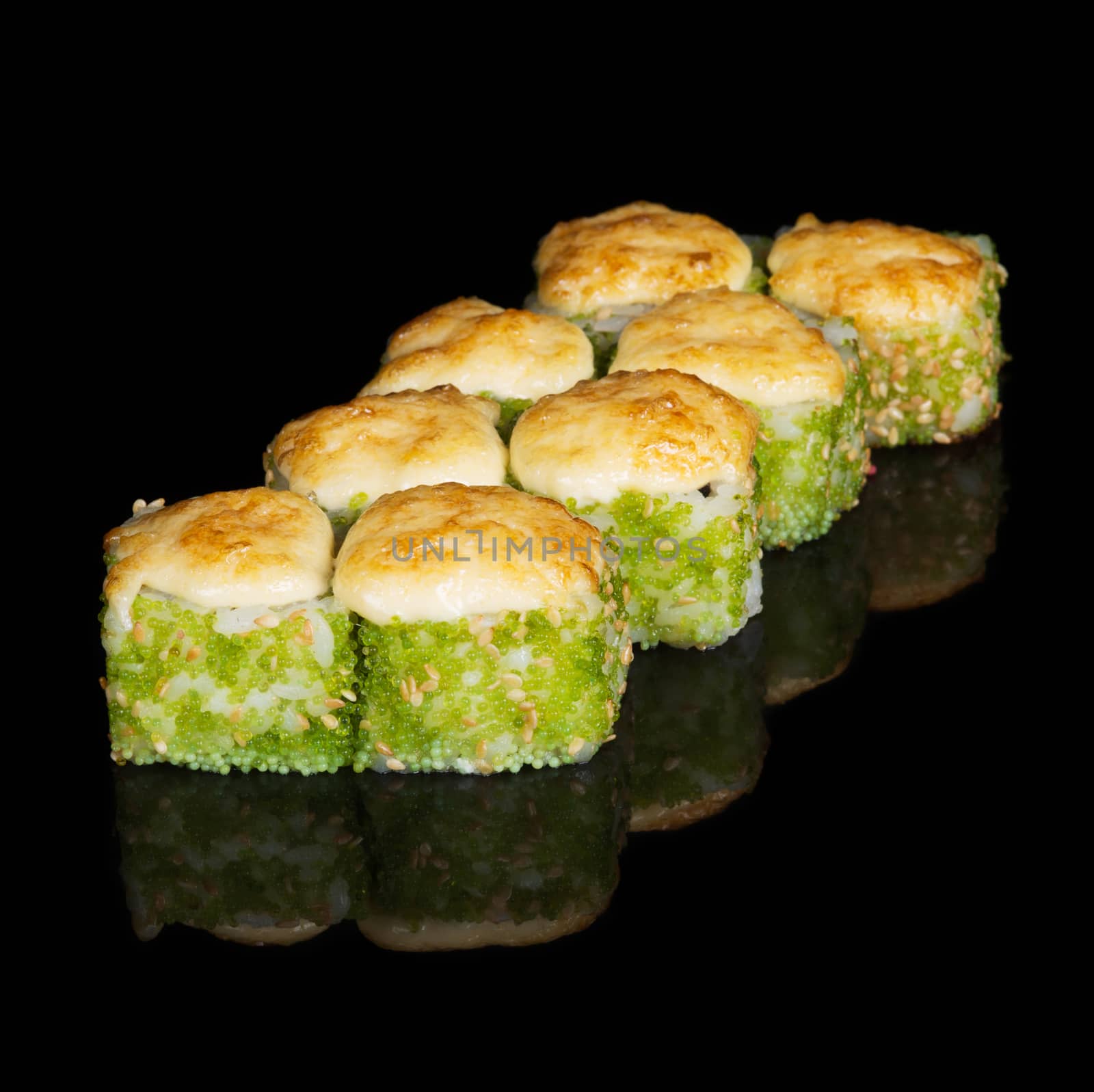 Grilled sushi rolls with caviar and cheese on  black background