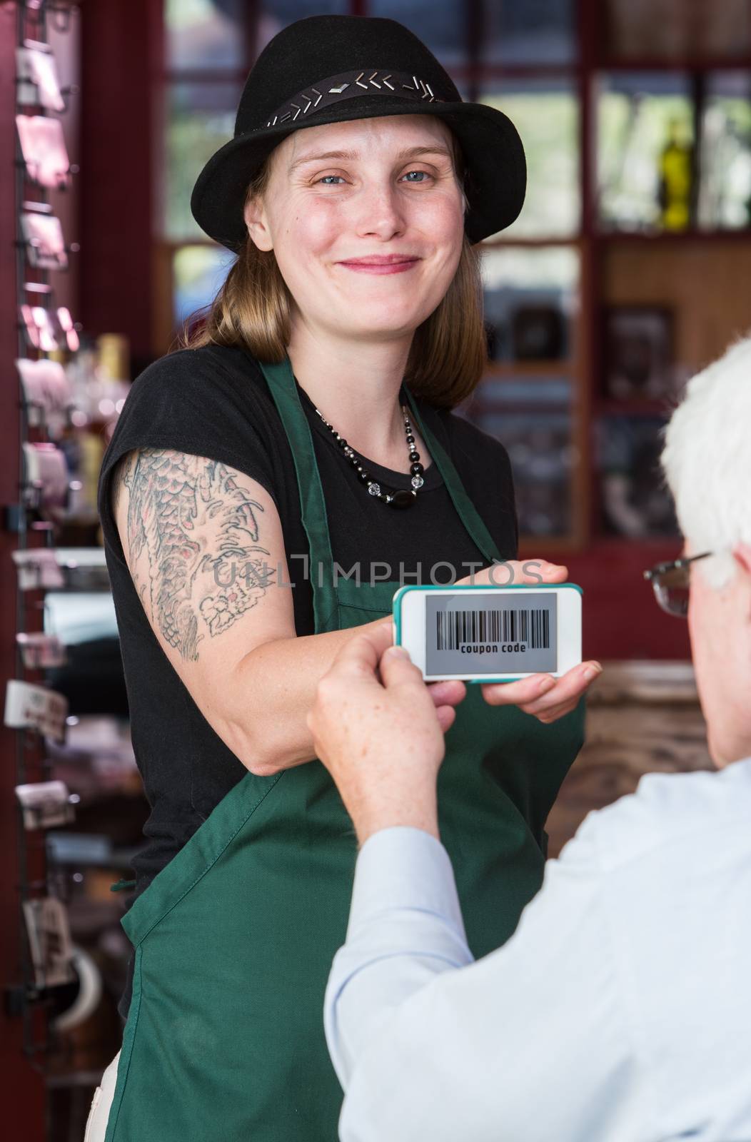 Waitress holding smart phone with coupon code by Creatista