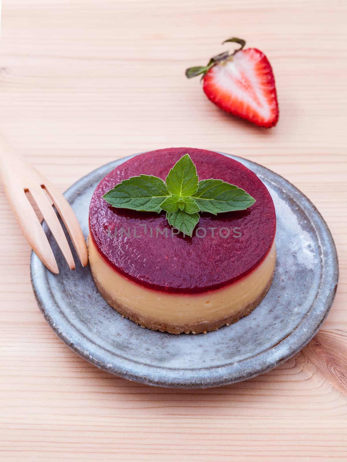 Strawberry cheesecake with fresh mint leaves on wooden backgroun by kerdkanno